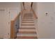 Wooden staircase with modern iron railings, leading to the upper level of the home at 3007 Holly St, Canton, GA 30115