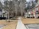 Charming townhomes featuring neat lawns and a central walkway leading to a distant white fence at 20 Pine Canyon Sw Dr # 41, Atlanta, GA 30331