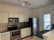 Well-lit kitchen with stainless appliances, dark countertops, and wood-look floors at 20 Pine Canyon Sw Dr # 41, Atlanta, GA 30331