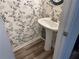 Stylish powder room featuring a pedestal sink and decorative wallpaper at 20 Pine Canyon Sw Dr # 41, Atlanta, GA 30331