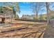 A view of the expansive backyard, featuring a garden, mature trees, and privacy fence at 2021 Cockrell Pointe Nw, Kennesaw, GA 30152