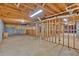 Unfinished basement with exposed wood ceiling beams, wood frames and concrete floor at 2021 Cockrell Pointe Nw, Kennesaw, GA 30152