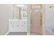 Well-lit bathroom features a white vanity, framed mirror, and glass shower door at 2021 Cockrell Pointe Nw, Kennesaw, GA 30152