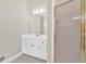 Bathroom features a white vanity, framed mirror, and glass shower door at 2021 Cockrell Pointe Nw, Kennesaw, GA 30152