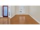 Bright bedroom with hardwood floors, plantation shutters, and glass front door at 2021 Cockrell Pointe Nw, Kennesaw, GA 30152