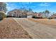 Attractive brick home with a long driveway, manicured landscaping and a spacious front yard at 2021 Cockrell Pointe Nw, Kennesaw, GA 30152