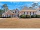 Charming brick home featuring manicured landscaping and a well-maintained front lawn at 2021 Cockrell Pointe Nw, Kennesaw, GA 30152