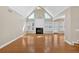 Bright living room features hardwood floors, a fireplace, and many windows at 2021 Cockrell Pointe Nw, Kennesaw, GA 30152