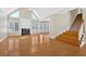 Bright living room with vaulted ceilings, fireplace, hardwood floors, and ample natural light through large windows at 2021 Cockrell Pointe Nw, Kennesaw, GA 30152