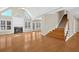 Living room with fireplace, many windows, and wooden staircase at 2021 Cockrell Pointe Nw, Kennesaw, GA 30152