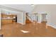 Open living area featuring hardwood floors with a view of the kitchen and staircase at 2021 Cockrell Pointe Nw, Kennesaw, GA 30152