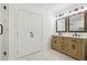 Bathroom with a double vanity, granite countertops, and modern light fixtures at 2765 Ocean Valley Dr, Atlanta, GA 30349