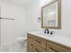 Well-lit bathroom featuring a wood vanity with sleek countertops at 2765 Ocean Valley Dr, Atlanta, GA 30349