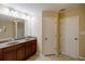 Bathroom with double sink vanity, granite counters, and large mirror at 4400 Village Field Pl, Suwanee, GA 30024