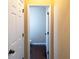 Hallway view of a half bathroom with modern fixtures and neutral decor at 4400 Village Field Pl, Suwanee, GA 30024
