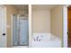 Bathroom with glass-enclosed shower and soaking tub at 4400 Village Field Pl, Suwanee, GA 30024