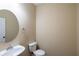 Cozy powder room includes a vanity with a round mirror, a toilet and good lighting at 4400 Village Field Pl, Suwanee, GA 30024