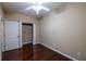 This bedroom features hardwood floors, a ceiling fan, and a closet with shelving at 4400 Village Field Pl, Suwanee, GA 30024