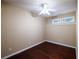 Bedroom with hardwood floors, ceiling fan, and natural light at 4400 Village Field Pl, Suwanee, GA 30024