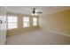 Spacious bedroom featuring multiple windows and a ceiling fan for comfort at 4400 Village Field Pl, Suwanee, GA 30024