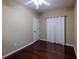 This bedroom features hardwood floors, a closet with curtain, and white walls at 4400 Village Field Pl, Suwanee, GA 30024