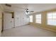 Well-lit bedroom with custom built-in closet storage and large windows at 4400 Village Field Pl, Suwanee, GA 30024