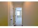 Hallway view showcasing the interior doors and transition to a sunlit room at 4400 Village Field Pl, Suwanee, GA 30024