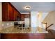 Updated kitchen boasts granite countertops, dark wood cabinetry, and stainless steel appliances at 4400 Village Field Pl, Suwanee, GA 30024