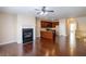 Open-concept living room boasts hardwood floors and fireplace, connecting to a kitchen with a breakfast bar at 4400 Village Field Pl, Suwanee, GA 30024