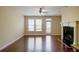Sun-filled living room featuring a fireplace, hardwood floors, and bright windows at 4400 Village Field Pl, Suwanee, GA 30024