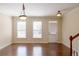 Bright living room features hardwood floors, two light fixtures and a back door at 4400 Village Field Pl, Suwanee, GA 30024