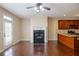 Spacious living room showcases a cozy fireplace and is adjacent to a modern kitchen at 4400 Village Field Pl, Suwanee, GA 30024