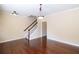 Bright living room features hardwood floors, crown molding, stairs to second floor and a light fixture at 4400 Village Field Pl, Suwanee, GA 30024