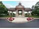 Stone and timber pavilion with manicured landscaping for gathering and relaxing in Village Grove at 4400 Village Field Pl, Suwanee, GA 30024