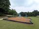 Community playground with swingset and play area, offers recreational opportunities within Village Grove at 4400 Village Field Pl, Suwanee, GA 30024