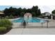 Community pool with seating and shelter, offers a refreshing escape within Village Grove at 4400 Village Field Pl, Suwanee, GA 30024