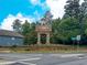 Community entrance sign with stone pillars and lush landscaping welcoming you to Village Grove at 4400 Village Field Pl, Suwanee, GA 30024