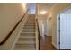 Staircase with carpeted steps and hardwood floors in the hallway at 4400 Village Field Pl, Suwanee, GA 30024