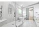 Bright bathroom featuring a glass shower, soaking tub, double vanity, and marble tiling at 632 Hunters Cove Ln., Loganville, GA 30052