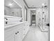 Bathroom with double vanity, black fixtures, huge mirror, and glass shower at 632 Hunters Cove Ln., Loganville, GA 30052