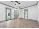 Spacious bedroom features neutral walls, gray trim, ceiling fan, and door to outdoor living space at 632 Hunters Cove Ln., Loganville, GA 30052