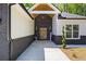 A modern home showcasing a sleek entrance with dark brick accents, a modern door, and a manicured lawn at 632 Hunters Cove Ln., Loganville, GA 30052