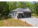 Angle view of the home showing the modern garage doors, brick and siding exterior, and landscaping at 632 Hunters Cove Ln., Loganville, GA 30052