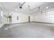 The three car garage is spacious with white walls, bright lighting, and a water heater at 632 Hunters Cove Ln., Loganville, GA 30052
