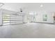 Spacious three car garage featuring bright lighting, white walls, and glass paneled garage doors at 632 Hunters Cove Ln., Loganville, GA 30052