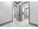 Hallway featuring multiple doorways and views into other rooms with marble flooring at 632 Hunters Cove Ln., Loganville, GA 30052