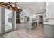 Open-concept kitchen featuring a large island, modern lighting, and views of the living area at 632 Hunters Cove Ln., Loganville, GA 30052