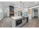 Modern kitchen features a large island, stainless steel appliances, and a cozy fireplace at 632 Hunters Cove Ln., Loganville, GA 30052