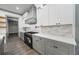 Modern kitchen features white cabinets, quartz countertops, stainless steel appliances and gray cabinets at 632 Hunters Cove Ln., Loganville, GA 30052