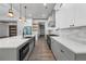 Contemporary kitchen boasts white cabinets, stainless steel appliances, and an island at 632 Hunters Cove Ln., Loganville, GA 30052